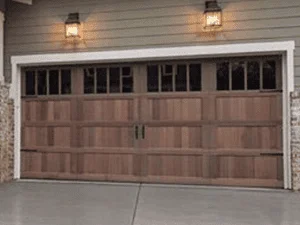 Two-car garage door with wood-grain finish, recessed panels, and upper windows